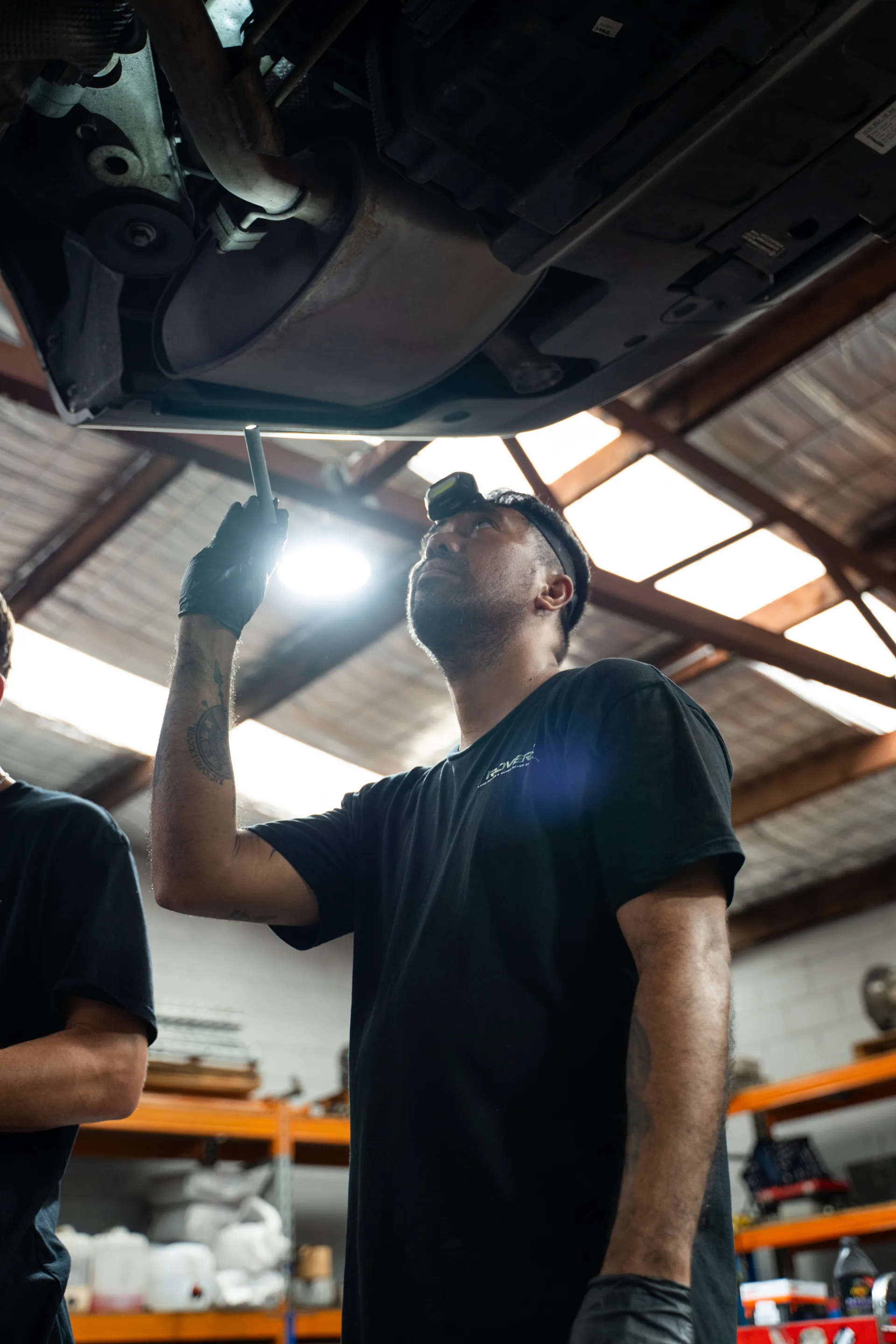 RoverX technicians working on a Land Rover on the hoist in Kirrawee