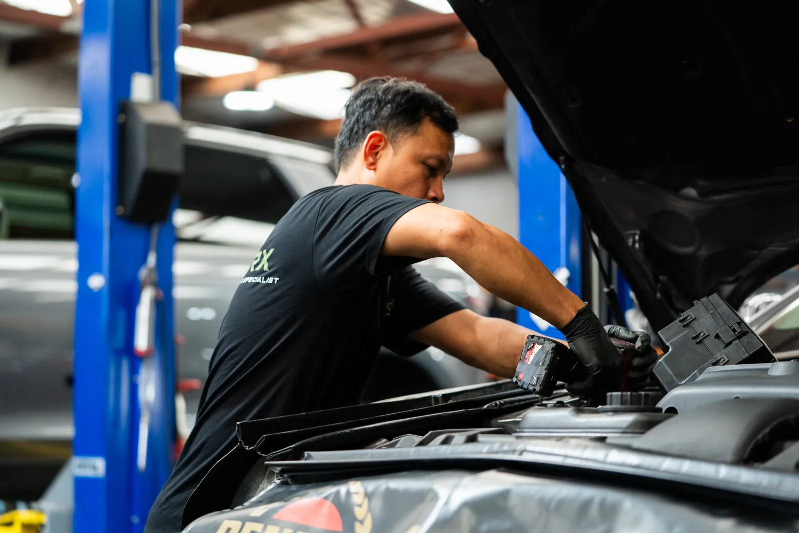 RoverX technician working in a Land Rover engine bay